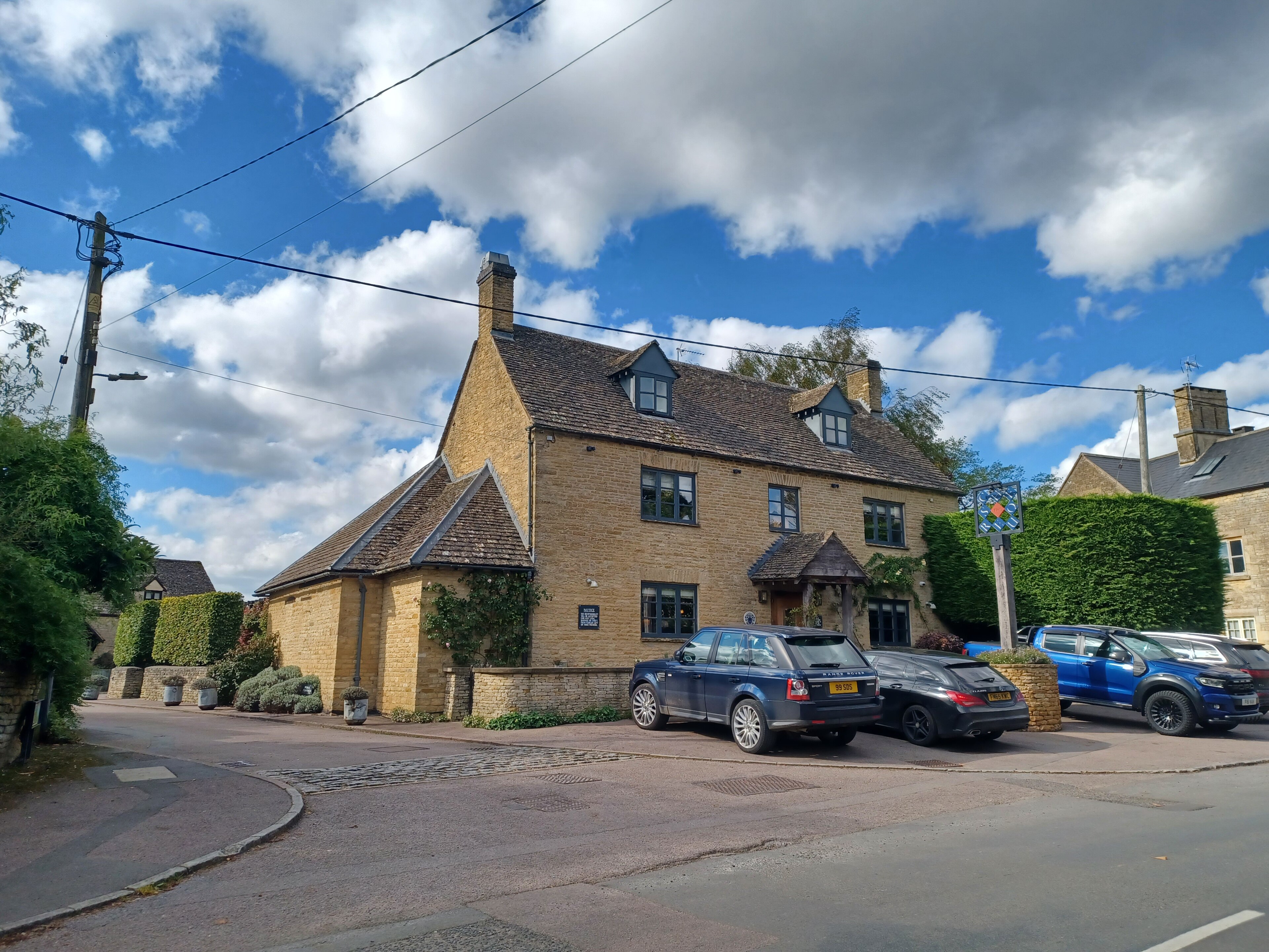 The Chequers pub on Church Road, Churchill, Oxfordshire, built in honey Cotswold stone